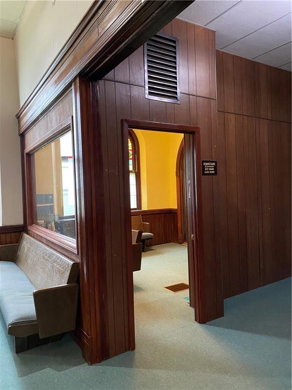 220 N 9th St, Atchison, KS 66002 - corridor featuring wooden walls, carpet floors, and arched walkways
