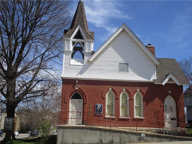 220 N 9th St, Atchison, KS 66002 - view of front facade featuring brick siding and a chimney