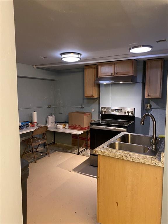 220 N 9th St, Atchison, KS 66002 - kitchen featuring a sink, stainless steel electric stove, under cabinet range hood, concrete floors, and light countertops