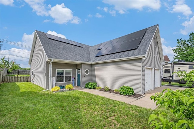 19204 E 15th Terrace Ct N, Independence, MO 64056 - view of front of property with a shingled roof, roof mounted solar panels, and a garage