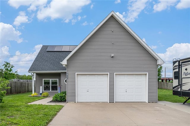 19204 E 15th Terrace Ct N, Independence, MO 64056 - view of front of property with roof mounted solar panels, driveway, and a shingled roof