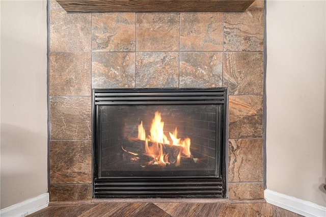 19204 E 15th Terrace Ct N, Independence, MO 64056 - detailed view of a tile fireplace, baseboards, and wood finished floors