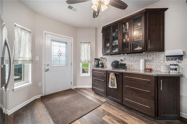 19204 E 15th Terrace Ct N, Independence, MO 64056 - bar area with stainless steel fridge, ceiling fan, dark wood-style floors, tasteful backsplash, and baseboards
