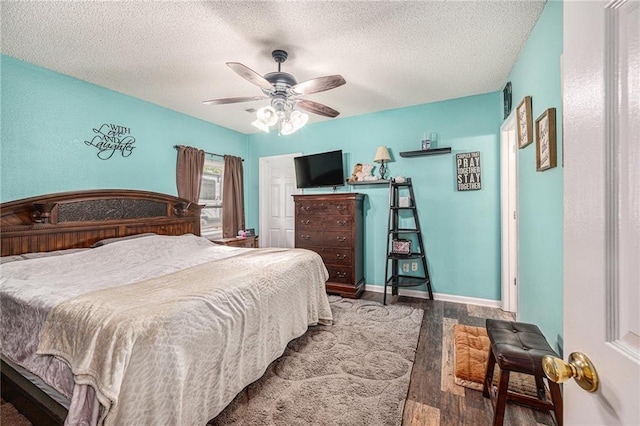 19204 E 15th Terrace Ct N, Independence, MO 64056 - bedroom with wood finished floors, a textured ceiling, a ceiling fan, and baseboards