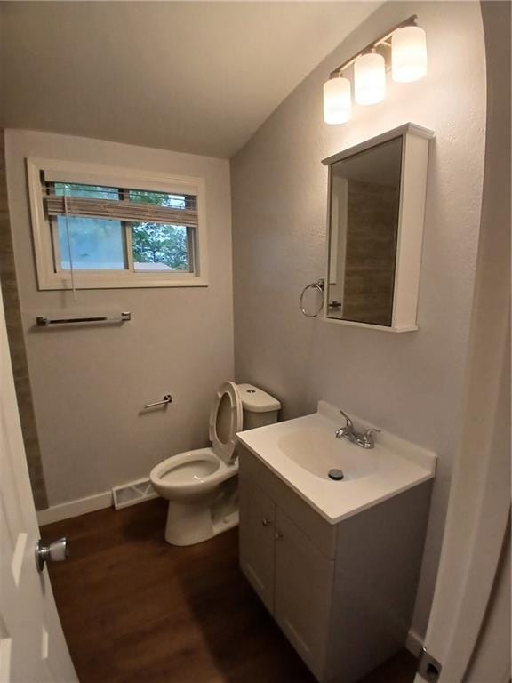 1029 Shearer Rd, Kansas City, KS 66103 - bathroom featuring wood finished floors, vanity, and toilet