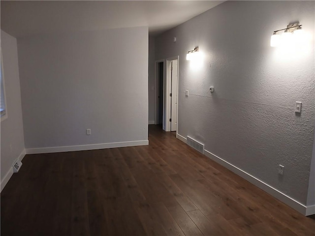 1029 Shearer Rd, Kansas City, KS 66103 - empty room with dark wood-style flooring and baseboards