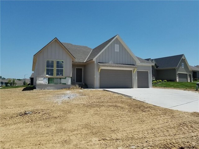 4615 N 144th Ter, Basehor, KS 66007 - modern farmhouse featuring board and batten siding, an attached garage, driveway, and roof with shingles
