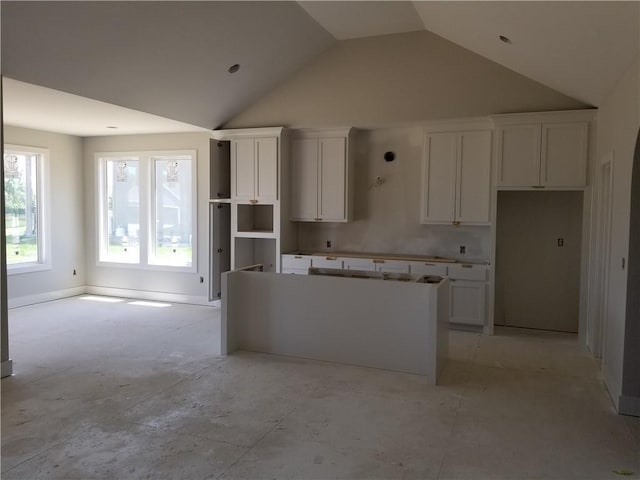 4615 N 144th Ter, Basehor, KS 66007 - kitchen with a center island, white cabinetry, and high vaulted ceiling