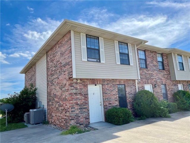 596 SE 105th Rd, Warrensburg, MO 64093 - view of property with central AC and brick siding