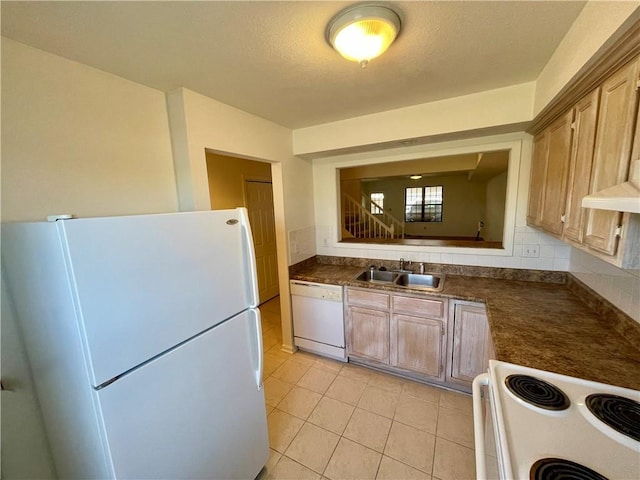 596 SE 105th Rd, Warrensburg, MO 64093 - kitchen with white appliances, a sink, light tile patterned floors, and dark countertops