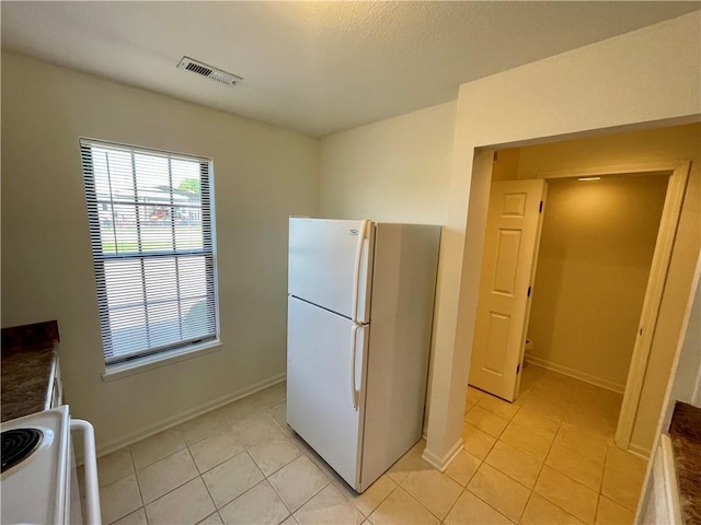 596 SE 105th Rd, Warrensburg, MO 64093 - kitchen with white appliances, light tile patterned flooring, and baseboards