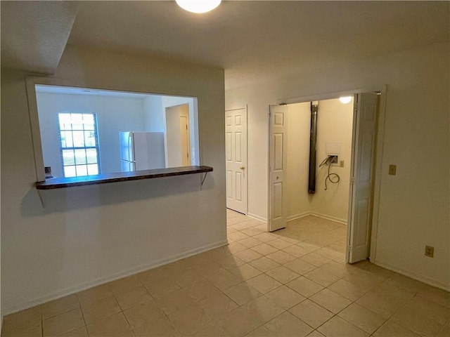 596 SE 105th Rd, Warrensburg, MO 64093 - hall featuring light tile patterned floors and baseboards