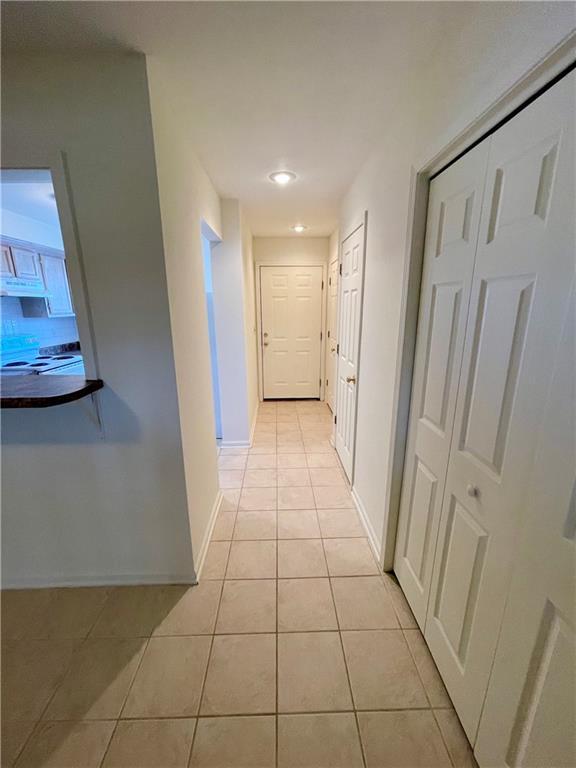 596 SE 105th Rd, Warrensburg, MO 64093 - corridor featuring light tile patterned flooring, baseboards, and recessed lighting
