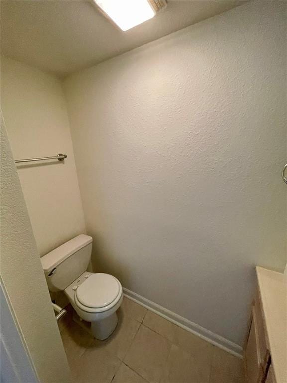 596 SE 105th Rd, Warrensburg, MO 64093 - bathroom featuring toilet, tile patterned flooring, and baseboards