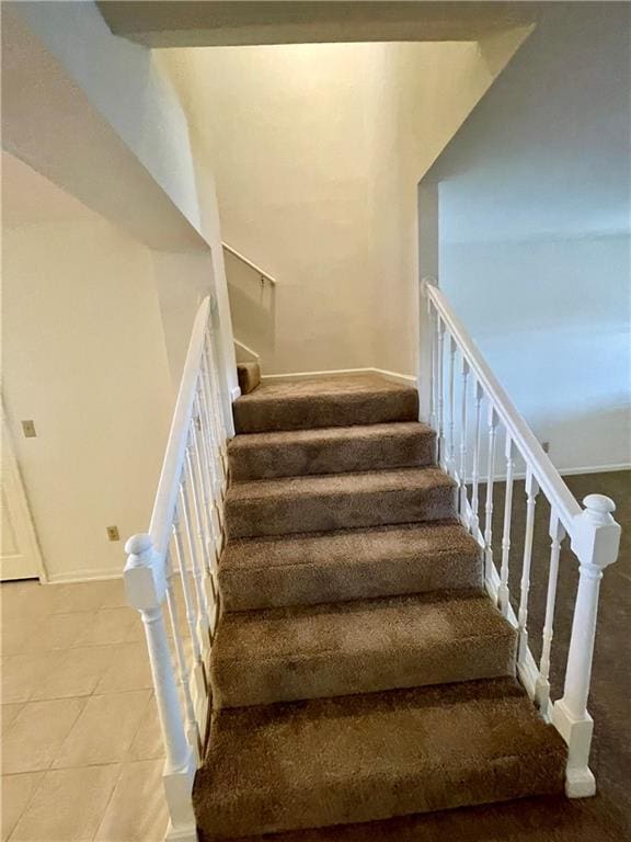 596 SE 105th Rd, Warrensburg, MO 64093 - staircase with baseboards and tile patterned floors