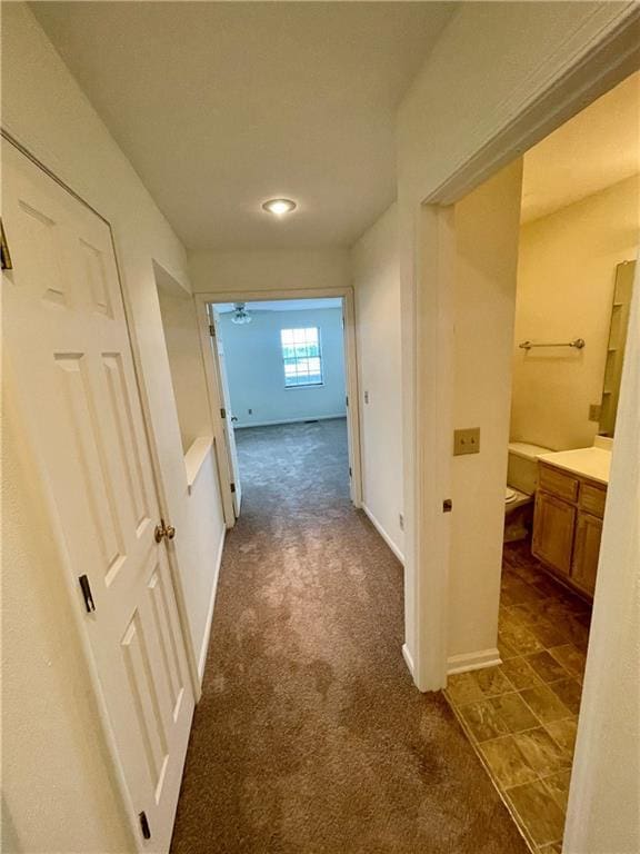 596 SE 105th Rd, Warrensburg, MO 64093 - hallway featuring dark colored carpet and baseboards