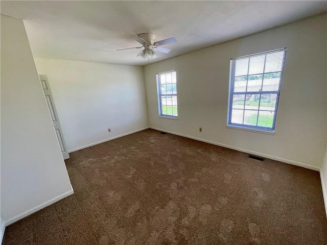 596 SE 105th Rd, Warrensburg, MO 64093 - spare room with dark colored carpet, a ceiling fan, and baseboards