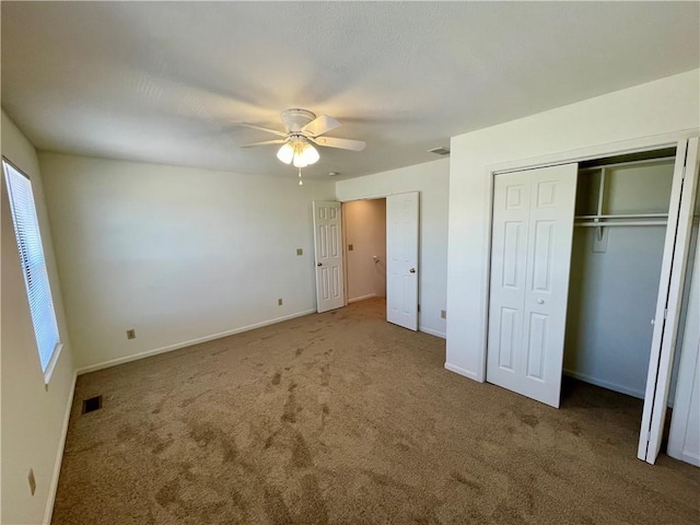 596 SE 105th Rd, Warrensburg, MO 64093 - unfurnished bedroom featuring carpet floors, a ceiling fan, and baseboards
