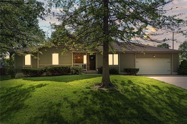 1036 NE Remington Ct, Lees Summit, MO 64086 - view of front of home featuring an attached garage, driveway, a front lawn, and stucco siding