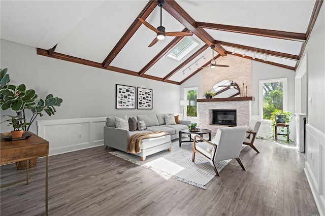 1036 NE Remington Ct, Lees Summit, MO 64086 - living area with ceiling fan, beam ceiling, plenty of natural light, wood finished floors, and wainscoting