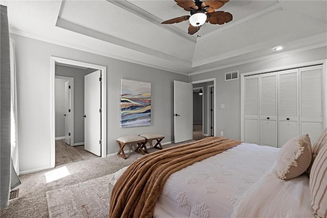 1036 NE Remington Ct, Lees Summit, MO 64086 - bedroom featuring a raised ceiling, carpet flooring, ornamental molding, baseboards, and a closet