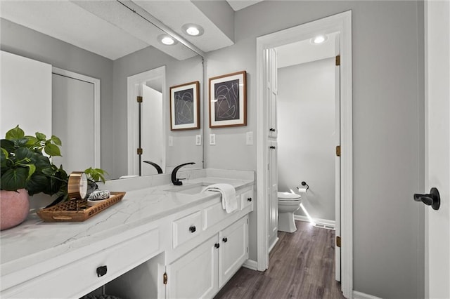 1036 NE Remington Ct, Lees Summit, MO 64086 - bathroom with toilet, wood finished floors, baseboards, and vanity