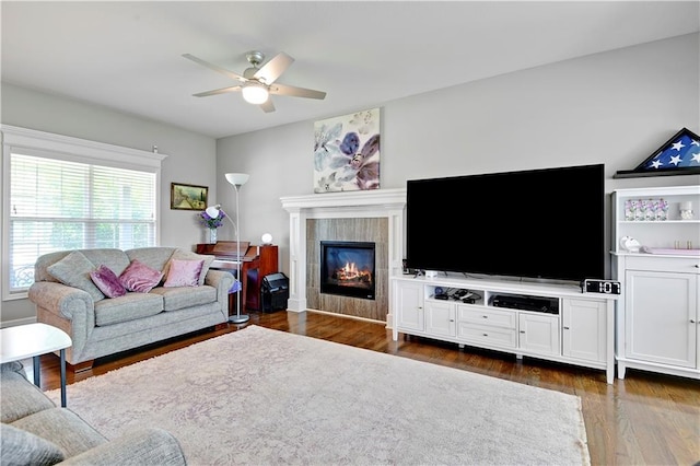 25201 W 149th Ter, Olathe, KS 66061 - living area featuring ceiling fan, a tiled fireplace, and dark wood-type flooring