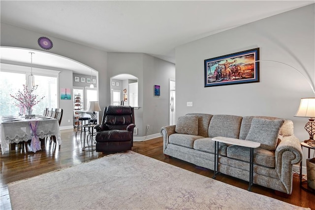 25201 W 149th Ter, Olathe, KS 66061 - living area with arched walkways, wood finished floors, and a chandelier