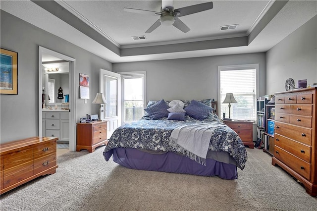 25201 W 149th Ter, Olathe, KS 66061 - bedroom featuring light carpet, ornamental molding, a tray ceiling, connected bathroom, and a ceiling fan