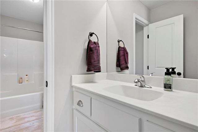 25201 W 149th Ter, Olathe, KS 66061 - full bath featuring vanity, shower / tub combination, and wood finished floors