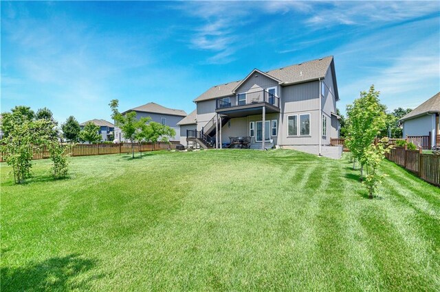 25201 W 149th Ter, Olathe, KS 66061 - rear view of house with a fenced backyard, a balcony, and stairs