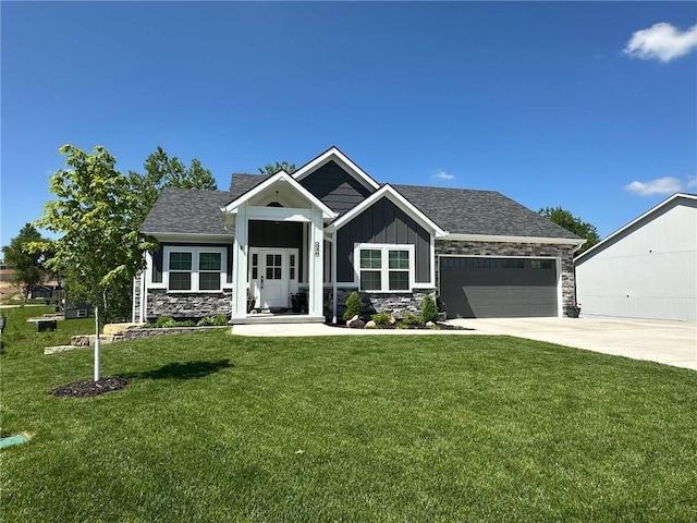 546 N Oakwood Ln, Tonganoxie, KS 66086 - craftsman-style house featuring stone siding, board and batten siding, concrete driveway, a garage, and a front yard