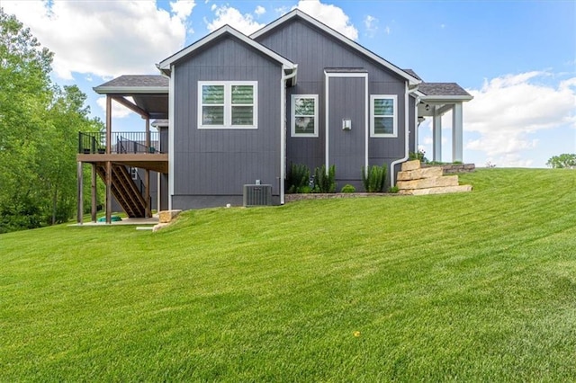 546 N Oakwood Ln, Tonganoxie, KS 66086 - rear view of house featuring a yard, stairway, and a deck