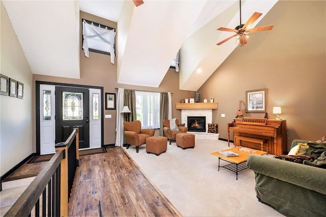 7277 SW Karen Rd, Trimble, MO 64492 - living room with high vaulted ceiling, a ceiling fan, a fireplace, wood finished floors, and baseboards