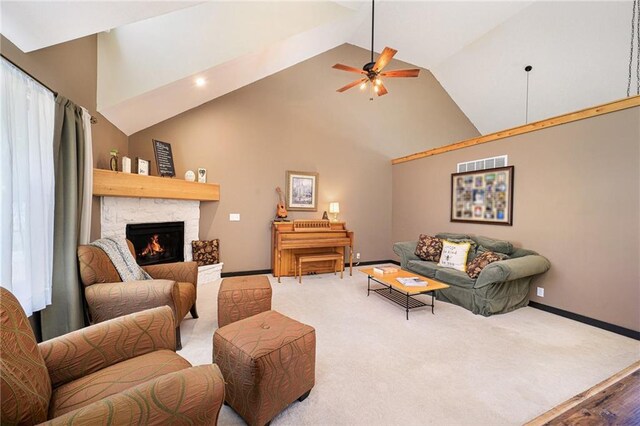 7277 SW Karen Rd, Trimble, MO 64492 - living area with high vaulted ceiling, baseboards, a stone fireplace, and a ceiling fan
