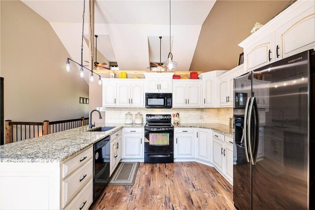 7277 SW Karen Rd, Trimble, MO 64492 - kitchen with black appliances, a sink, a peninsula, backsplash, and wood finished floors