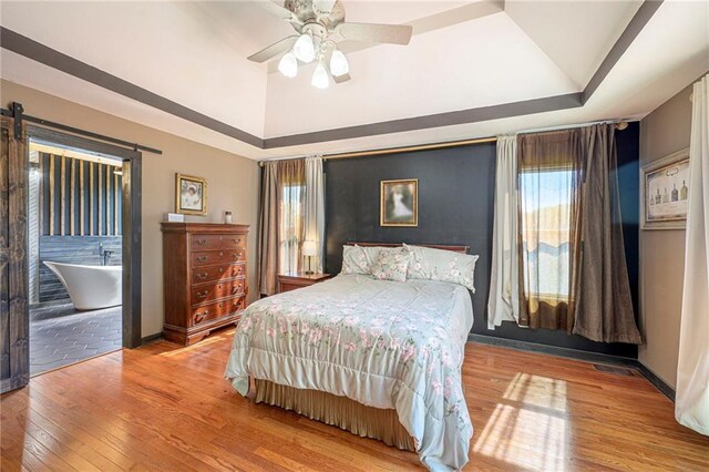 7277 SW Karen Rd, Trimble, MO 64492 - bedroom with hardwood / wood-style flooring, vaulted ceiling, a ceiling fan, and baseboards