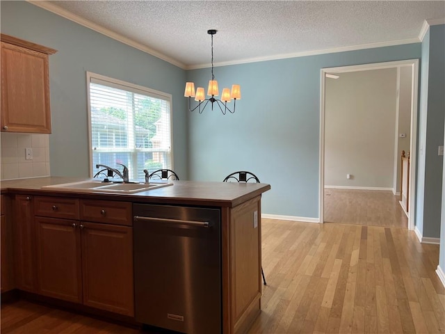 2017 S 137th St, Bonner Springs, KS 66012 - kitchen featuring stainless steel dishwasher, a sink, light wood-style floors, a chandelier, and a textured ceiling