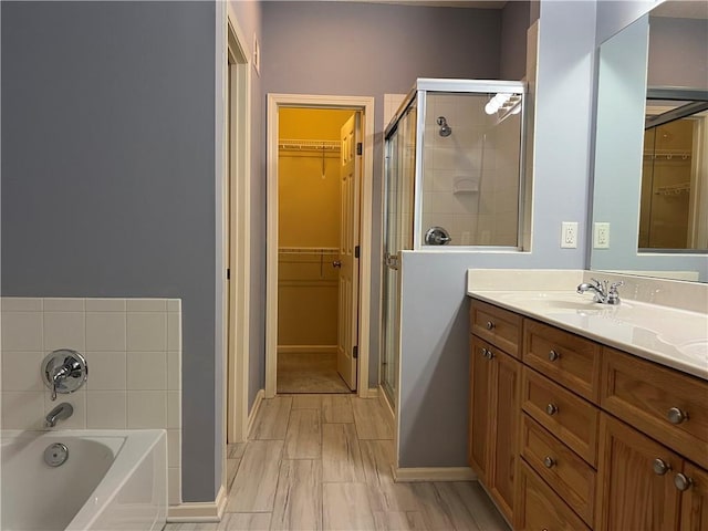 2017 S 137th St, Bonner Springs, KS 66012 - bathroom featuring a stall shower, a spacious closet, a garden tub, and double vanity