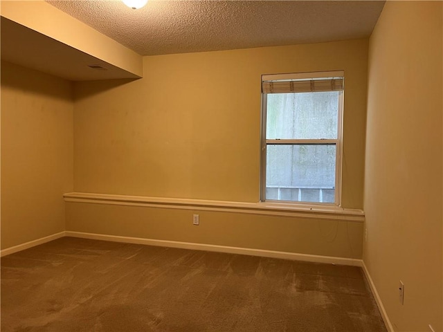 2017 S 137th St, Bonner Springs, KS 66012 - spare room featuring dark carpet, a textured ceiling, and baseboards