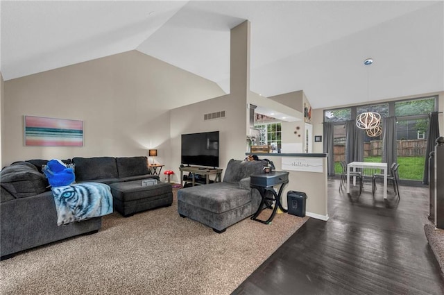 living room with high vaulted ceiling and wood finished floors