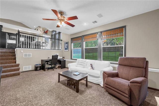 living area featuring carpet flooring, an office area, ceiling fan, stairway, and baseboards