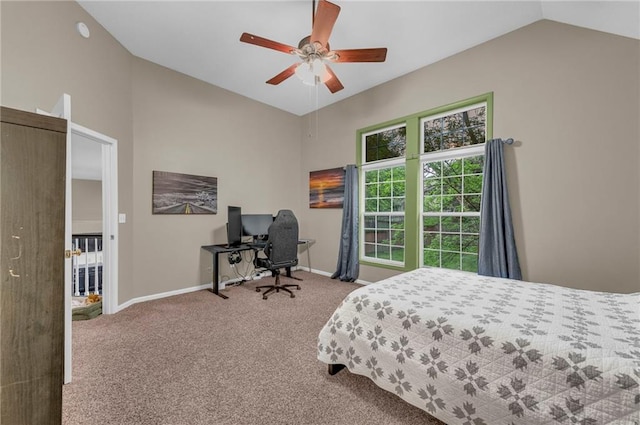 bedroom with lofted ceiling, carpet floors, baseboards, an office area, and a ceiling fan