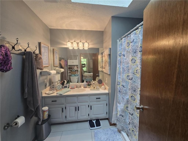 27349 Karrs Park Ave, Warsaw, MO 65355 - ensuite bathroom with a textured ceiling, tile patterned flooring, vanity, and a shower with shower curtain