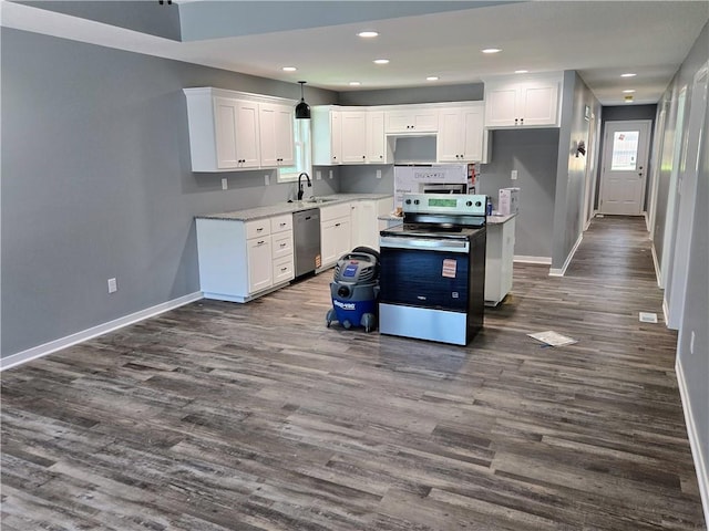 449 E Market St, Warrensburg, MO 64093 - kitchen with stainless steel appliances, dark wood finished floors, white cabinets, recessed lighting, and light countertops