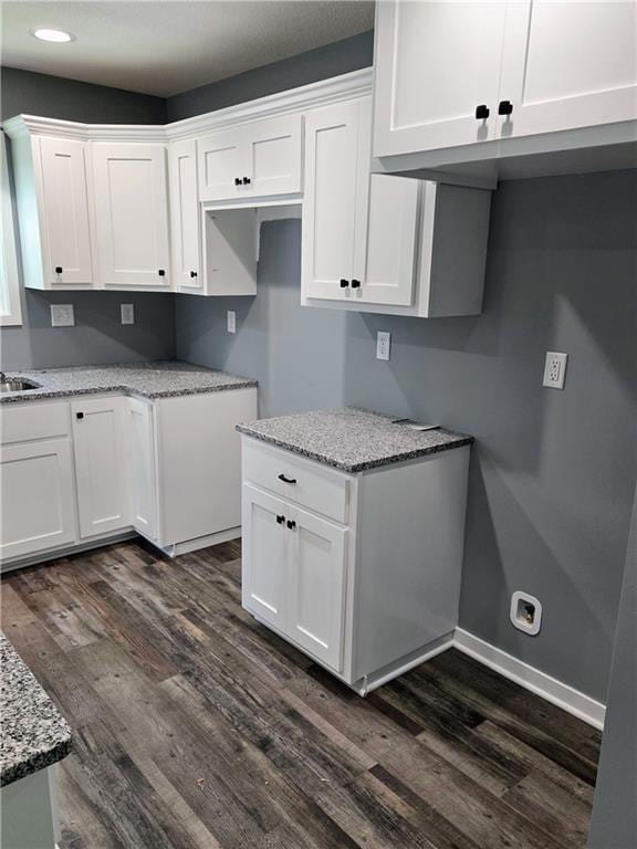 449 E Market St, Warrensburg, MO 64093 - kitchen featuring dark wood-type flooring, white cabinetry, light stone counters, and recessed lighting