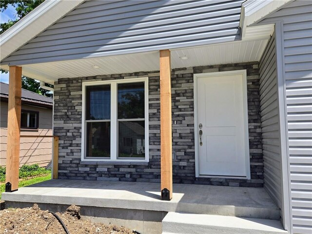 449 E Market St, Warrensburg, MO 64093 - view of exterior entry with covered porch and stone siding