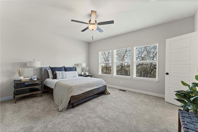402 Woodview Dr, Raymore, MO 64083 - carpeted bedroom with baseboards and a ceiling fan