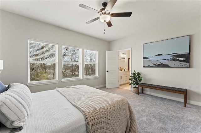 402 Woodview Dr, Raymore, MO 64083 - bedroom featuring light carpet, baseboards, ceiling fan, and ensuite bathroom