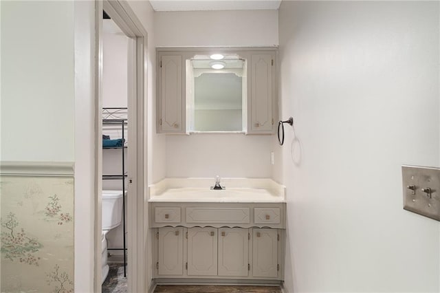 bathroom featuring toilet and vanity